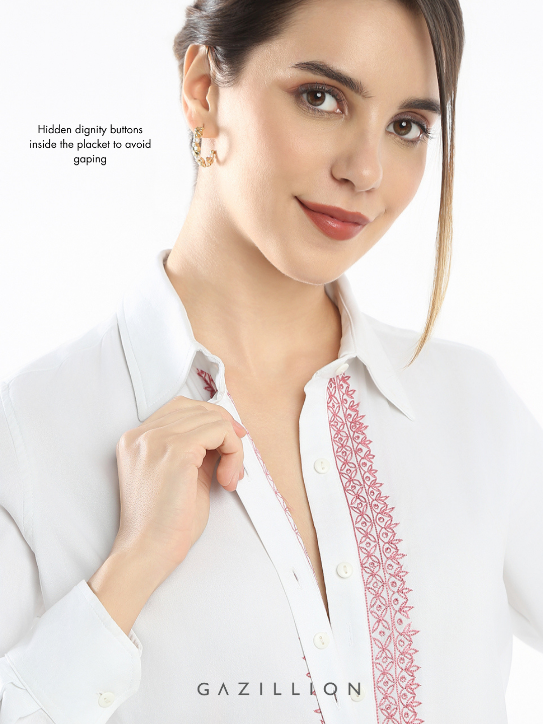 Woman wearing a white blouse with red embroidery